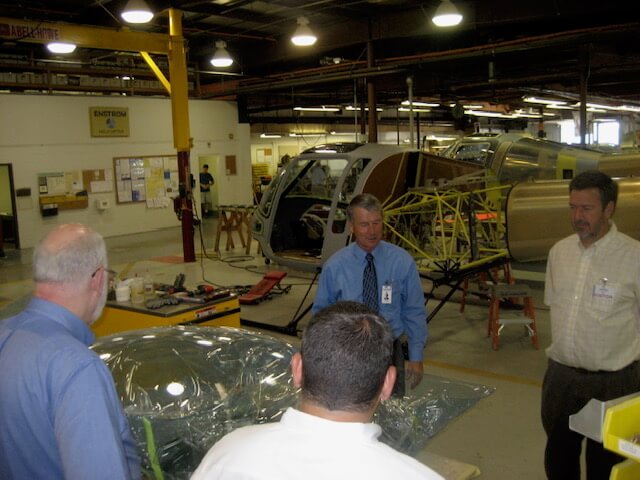 Chuck Surack touring Enstrom Helicopter with then president Jerry Mullins