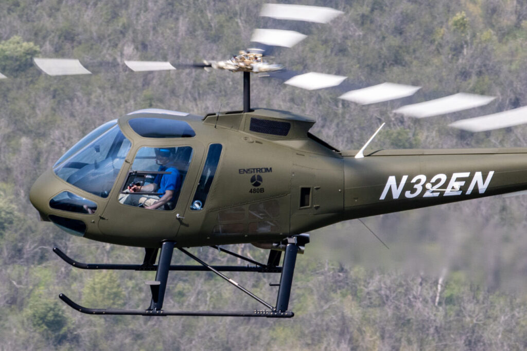 Enstrom military helicopter flying
