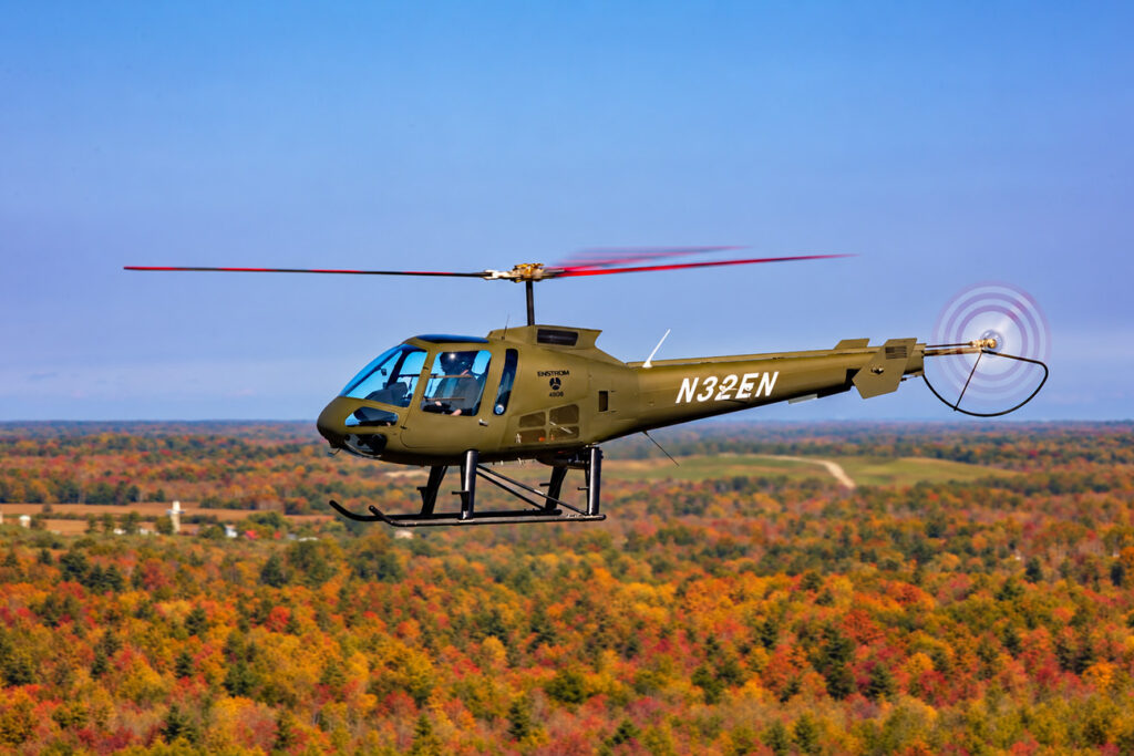 Enstrom Helicopter flying above fall oliage